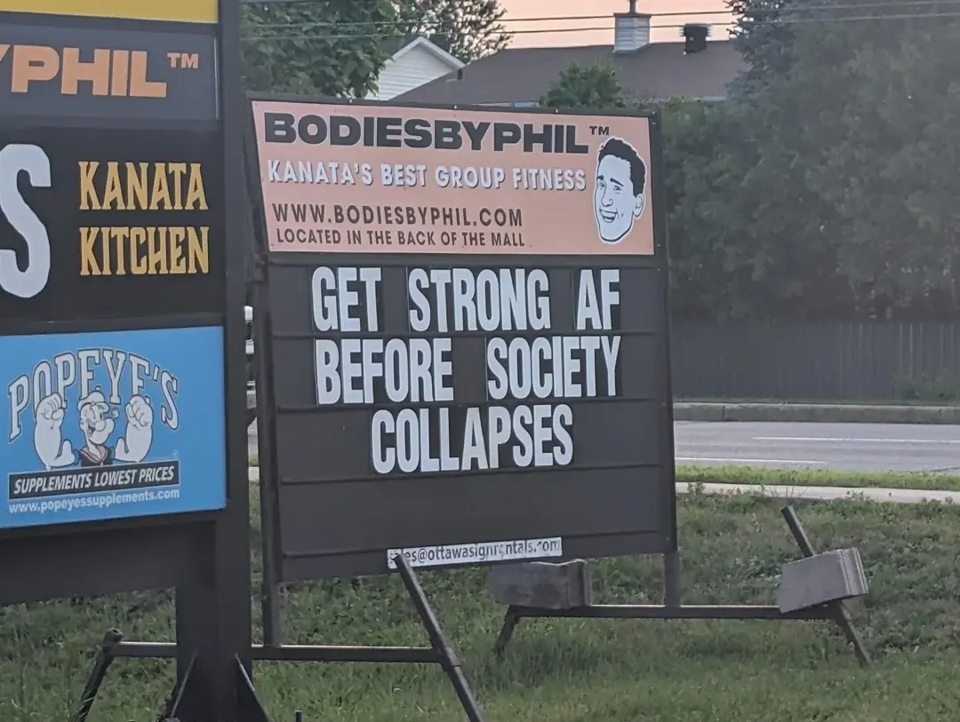 Gym sign ad reads: "Get strong AF before society collapses"